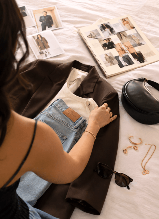 Holding up an outfit on a hanger